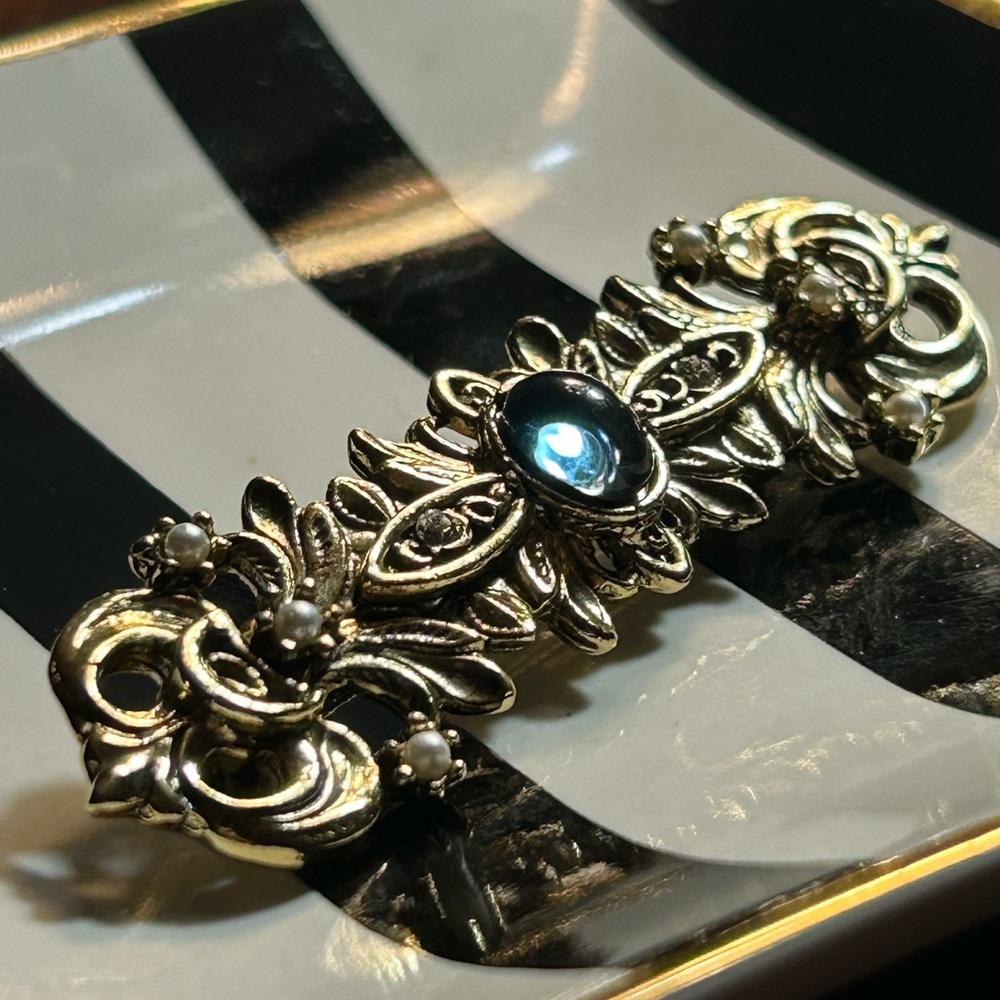 Vintage Gold-tone Ornate Brooch with a blue rhinestone